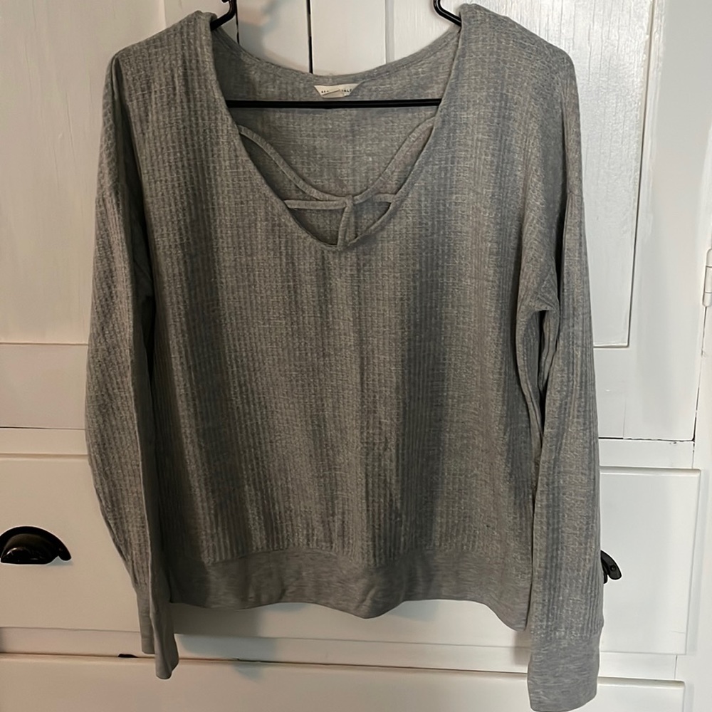 All grey long sleeve with cross ties along the chest.